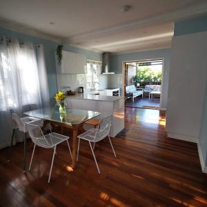 a kitchen and dining room with a table and chairs at OXLEY Private Heated Mineral Pool & Private Home in Brisbane