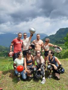 a group of people posing for a picture on a hill at HG Hostel and Motorbikes in Ha Giang