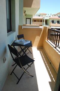 d'un balcon avec une table et une chaise. dans l'établissement Cerca del mar 500mbs WIFI, à Puertito de Güímar