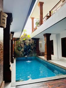 a swimming pool in the middle of a house at Milky Way Homestay Canggu in Canggu