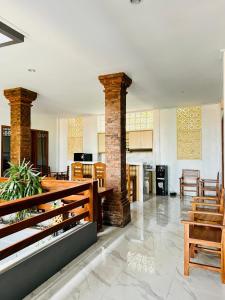 a large living room with a table and chairs at Milky Way Homestay Canggu in Canggu