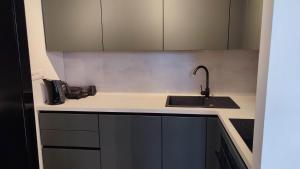 a kitchen with a sink and a counter top at Pohorje Pearl Lux, 2-floor apartment in Hočko Pohorje