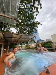 dos hombres en un jacuzzi en un complejo en Chinatown Hostel by Mingle en Kuala Lumpur