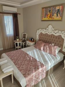 a bedroom with a large bed and a table at Basilica Guest House in Istanbul