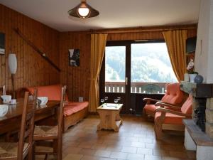 a living room with a couch and a table and a window at Appartement Le Grand-Bornand, 3 pièces, 6 personnes - FR-1-241-62 in Le Grand-Bornand