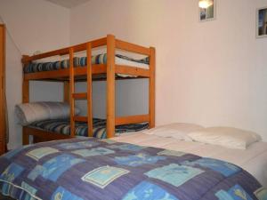 a bedroom with two bunk beds and a bed at Appartement Le Grand-Bornand, 2 pièces, 6 personnes - FR-1-241-106 in Le Grand-Bornand