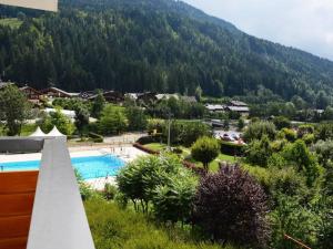 a resort with a swimming pool and a mountain at Appartement Le Grand-Bornand, 2 pièces, 6 personnes - FR-1-241-106 in Le Grand-Bornand