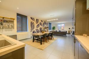 a kitchen and living room with a table and chairs at Villa Ma Bohème - 6 pers. in Charleville-Mézières