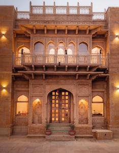 a building with a balcony on top of it at Dev Garh in Jaisalmer