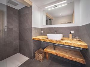 a bathroom with a sink and a mirror at Appartement Heim in Sankt Gallenkirch