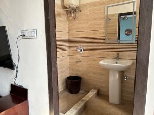 a bathroom with a sink and a mirror at The Aster Penthouse in Kolkata