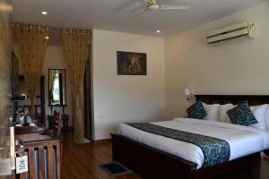 a bedroom with a large bed in a room at Prime Neelkanth Forest Retreat Resort in Tehla