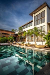 a swimming pool in front of a building at Ahana Resort El Nido in El Nido