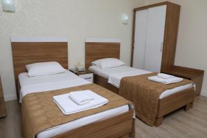 Postel nebo postele na pokoji v ubytování Hotel Binlik