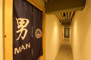 a hallway with a man banner on the wall at The Golden Ville Boutique Hotel and Spa in Pattaya Central