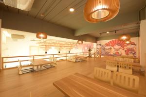 a room with tables and chairs and a painting on the wall at The Golden Ville Boutique Hotel and Spa in Pattaya Central