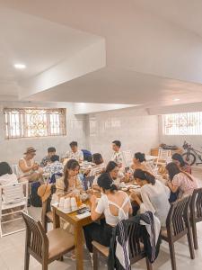 a group of people sitting at tables in a room at THE VILLA HIEU HY in Quy Nhon