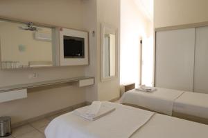 Postel nebo postele na pokoji v ubytování Hotel Binlik