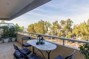 a balcony with a table and chairs and a view at Glyfada Center Sea View Apt in Athens