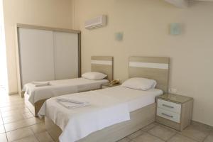 Postel nebo postele na pokoji v ubytování Hotel Binlik