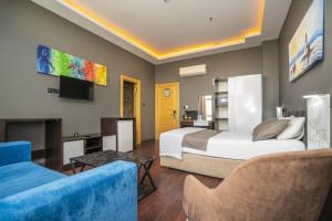 a hotel room with a bed and a couch at 216 Palace Suite in Istanbul