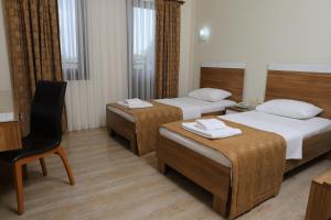 Postel nebo postele na pokoji v ubytování Hotel Binlik