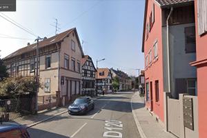 a small car parked on a street with buildings at Proche centre de Strasbourg et Parlement Européen in Schiltigheim