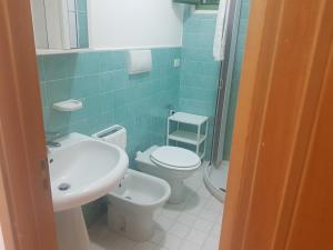 a bathroom with a white toilet and a sink at Appartamenti Oleandri Baia Verde in Gallipoli