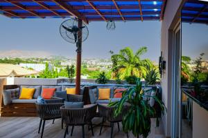 a patio with a couch and chairs at Wali's Suites in Abuja