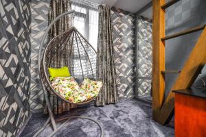 a hanging chair with a green pillow in a room at Hotel Central Club Sofia in Sofia