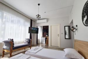a bedroom with a bed and a couch and a tv at Social House in Istanbul