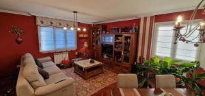 a living room with a couch and a table at Casa Anabel - Con garaje, 3 hab, 2 baños in Gijón