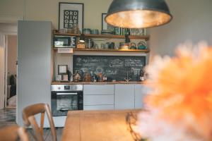 a kitchen with a table and a chalkboard at Edelsminde Bed & Breakfast in Haslev