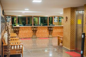 a lobby with a bar in a building at Hotel Le Pousse Pousse in Antananarivo