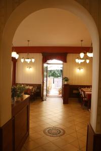 an archway in a restaurant with tables and chairs at Penzion Poříčí in Trutnov