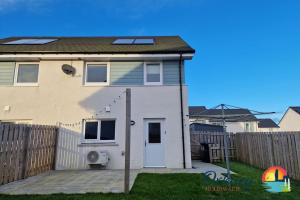 a house with a white door and a fence at 18 Gold Drive, Kirkwall, Orkney - OR00185F in Orkney