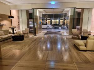 a lobby with couches and a car in a building at Luxe Waterfront Melbourne in Melbourne