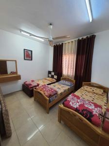 a room with two beds in a room at Abo Amer Apartments in Aqaba