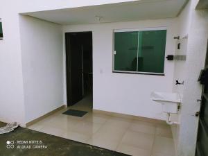 a bathroom with a sink and a window on a wall at Moria in Goiânia