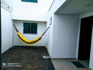 a yellow hammock hanging from a wall in a room at Moria in Goiânia