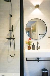 a bathroom with a sink and a mirror at Villa la Vida in Tilburg