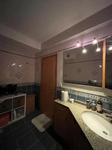 a bathroom with a sink and a large mirror at 3+1,villa, 10min to KadıköyPier in Istanbul