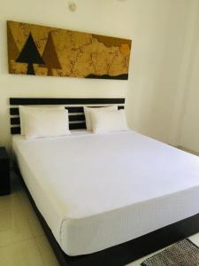 Postel nebo postele na pokoji v ubytování Sunrise Palace Negombo