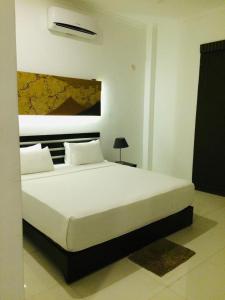 Postel nebo postele na pokoji v ubytování Sunrise Palace Negombo