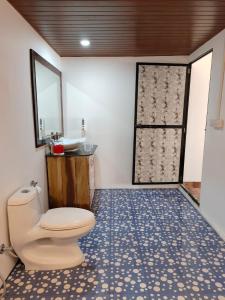 a bathroom with a toilet and a sink at Madhu Huts Agonda in Agonda