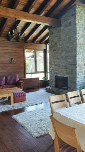 a living room with a couch and a fireplace at Gostnici Holiday Home in Razlog