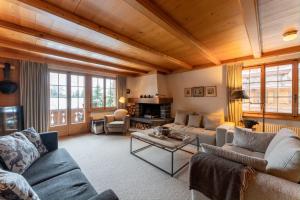 a living room with couches and a table at Cozy Place in Gstaad center in Gstaad