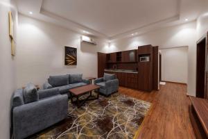 a living room with two couches and a table at Crown Towers for Hotel Suitesابراج التاج للشقق المخدومة in Jazan