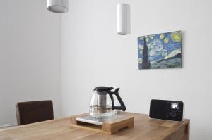 a blender on a wooden table with a painting on the wall at Apartment Hannover Top Citylage in Hannover