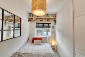 a small bedroom with a bed and a window at Guest Homes - Loughborough Road House in Leicester